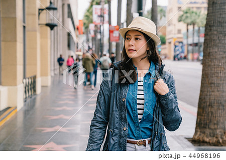 an elegant woman looking inside the show window 44968196