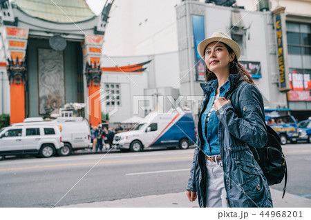 traveler relaxing standing with a confident smile 44968201