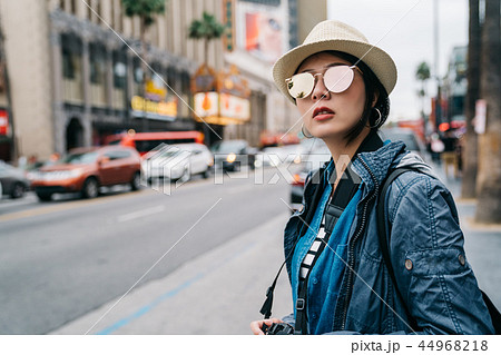 an elegant female traveler waiting for taxi 44968218