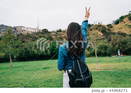 elegant female tourist showing victory sign elegant female tourist showing victory sign 44968271