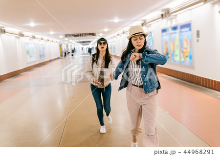 asian sisters are in a rush to catch the train asian sisters are in a rush to catch the train 44968291