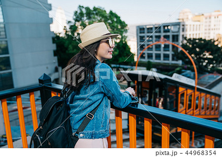 tourist putting hands on the handrail 44968354