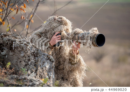 Wildlife photographer in the ghillie suit working Wildlife photographer in the ghillie suit working 44969020