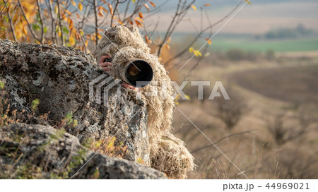 Wildlife photographer in the ghillie suit working 44969021