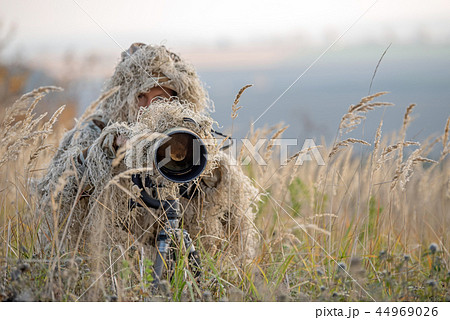 Wildlife photographer in the ghillie suit working 44969026