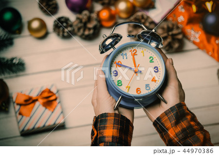child hands holding a clock child hands holding a clock 44970386