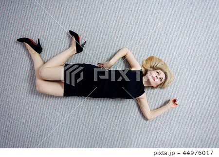 Beautiful dead woman in black dress lying on the floor. Beautiful dead woman in black dress lying on the floor. 44976017