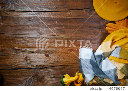 Autumn clothes top down view on wooden table Autumn clothes top down view on wooden table 44976047