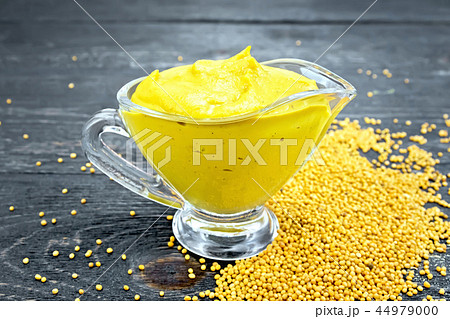 Sauce mustard in sauceboat on black board 44979000