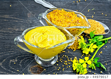 Sauce mustard in two sauceboats on wooden board Sauce mustard in two sauceboats on wooden board 44979017