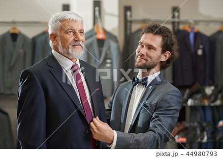 Close up of two elegant men coming to boutique on shopping. Close up of two elegant men coming to boutique on shopping. 44980793