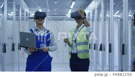 Diverse engineers with laptop in electrical station center 44981550