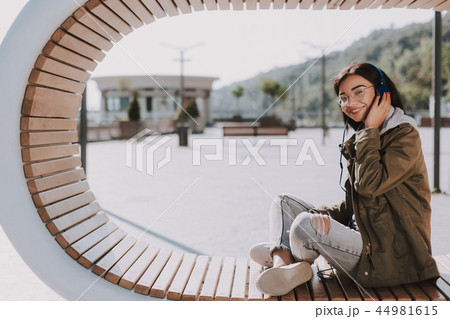 Joyful young woman enjoying best songs outdoors Joyful young woman enjoying best songs outdoors 44981615