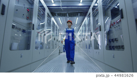 Asian worker walking in hallway of power station 44981626