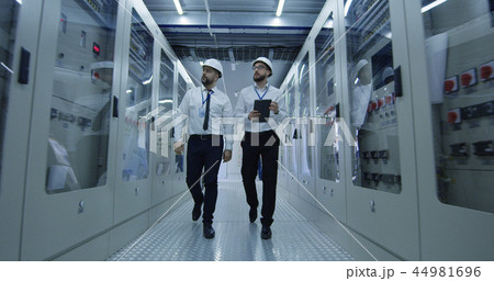 Diverse colleagues walking in power station center 44981696