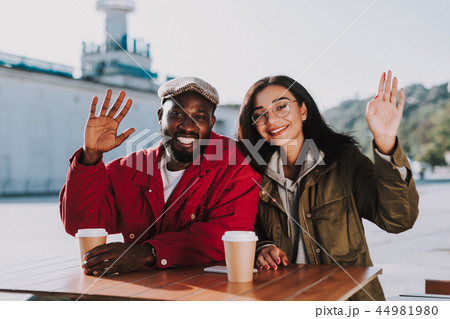 Emotional couple waving hands while sitting at the table Emotional couple waving hands while sitting at the table 44981980