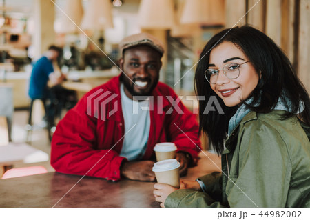 Young girl turning and looking at you while sitting with her boyfriend Young girl turning and looking at you while sitting with her boyfriend 44982002
