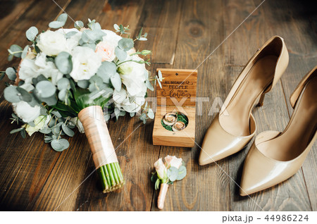 Wedding shoes of the bride together with a bouquet of natural flowers Wedding shoes of the bride together with a bouquet of natural flowers 44986224
