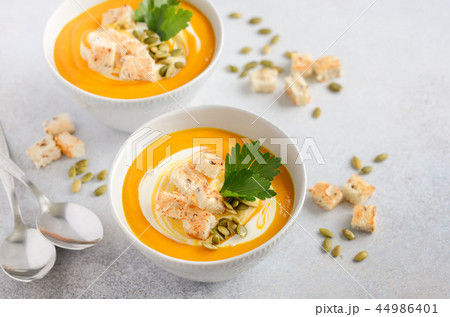 Pumpkin soup with cream, croutons, pumpkin seeds. 44986401