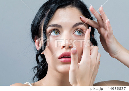 Young woman with contact lenses Young woman with contact lenses 44986827
