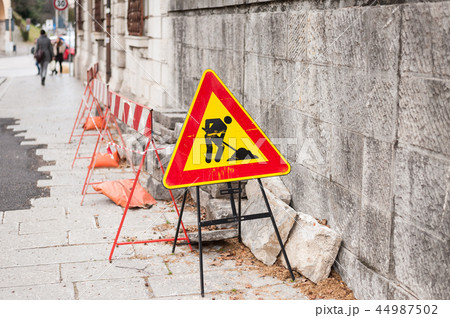 Construction zone sign by the road Construction zone sign by the road 44987502