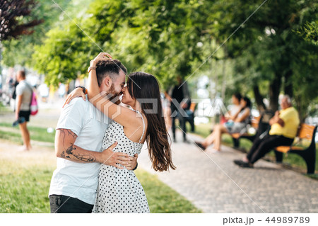 Handsome guy and young girl hugging in the park. Handsome guy and young girl hugging in the park. 44989789