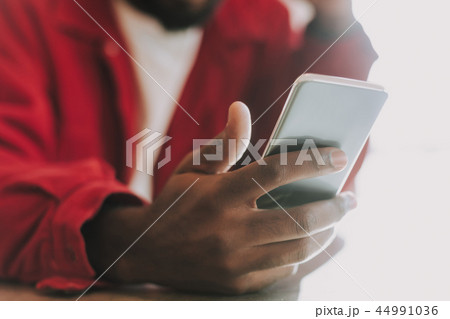 Close up of modern gadget in the hand of young man Close up of modern gadget in the hand of young man 44991036