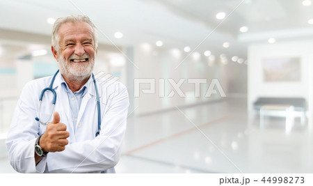 Happy senior doctor standing in the hospital. Happy senior doctor standing in the hospital. 44998273