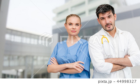 Doctors at hospital working with another doctor. 44998327