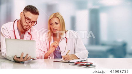 Doctors working with laptop computer in hospital. Doctors working with laptop computer in hospital. 44998755