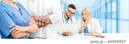 Doctor working in hospital with other doctors. 44998997