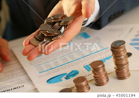 Hand businessman putting pin money into pig Hand businessman putting pin money into pig 45001194