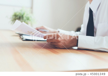 Businessman working at office with sign a document 45001349