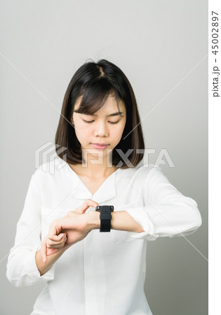 Woman touch screen digital clock in the display. 45002897