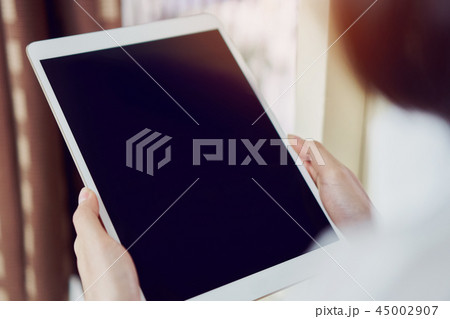 Woman using blank screen tablet. 45002907