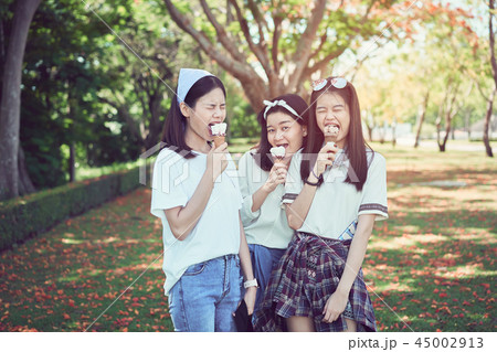 Young girl is eating ice cream and happy. Young girl is eating ice cream and happy. 45002913