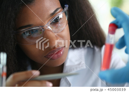 A male chemist holds test tube of glass 45003039