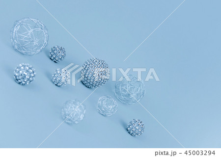 Silver shiny Christmas bauble decoration on pastel blue background. Silver shiny Christmas bauble decoration on pastel blue background. 45003294
