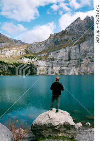 Hiker enjoing beautiful view of Lago di Braies or Pragser wildsee, Italy. 45003371