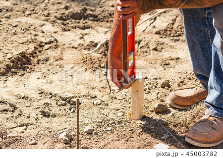 Worker Using Level At Constrcution Site Worker Using Level At Constrcution Site 45003782