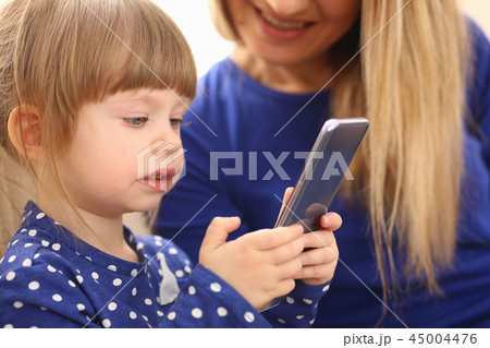 Cute little girl on floor carpet with mom 45004476