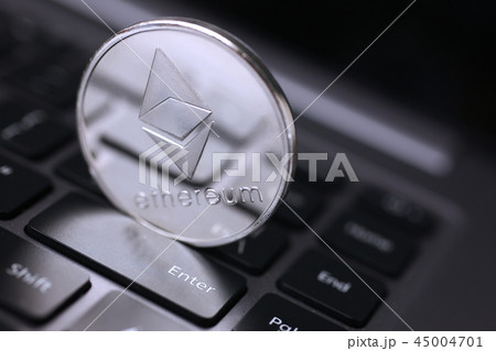 Silver ethereum coin is lying on laptop 45004701
