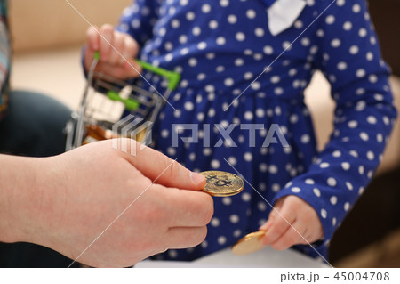 Little girl arm collecting crypto coins 45004708