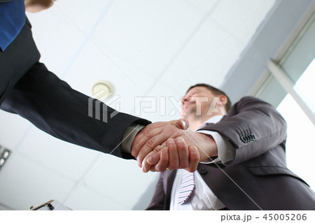 Man in suit shake hand as hello in office Man in suit shake hand as hello in office 45005206