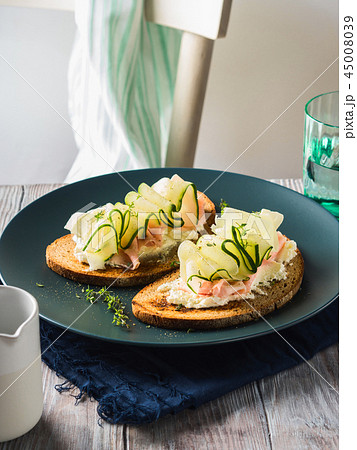 Rye bread toasts with cheese, ham, cucumber Rye bread toasts with cheese, ham, cucumber 45008039