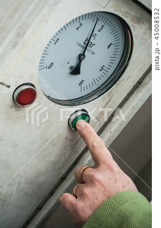 woman putting on green button to air tire presure woman putting on green button to air tire presure 45008532