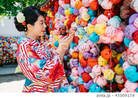 girl hanging praying ball on blessing wall 45009159