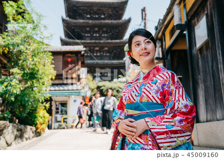 young girl curiously looking at Japanese street 45009160