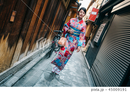 traveler wearing colorful kimono walking in alley 45009191