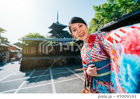 traveler taking selfie with pagoda in Kyoto 45009193